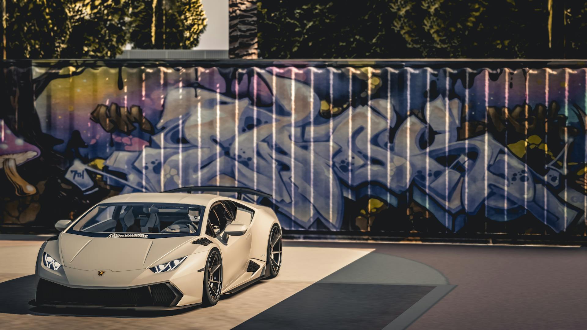 A Lamborghini sits parked outdoors in front of a wall filled with graffiti.