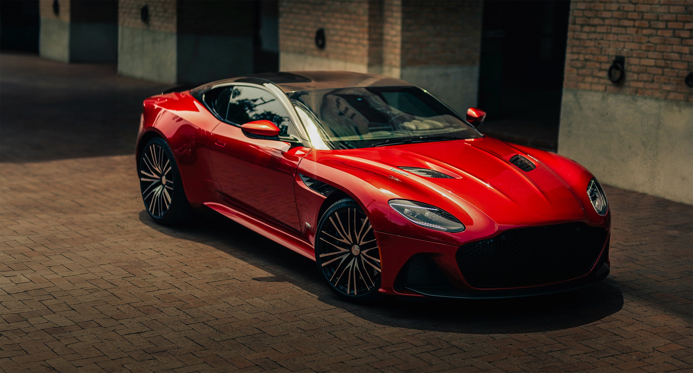 red aston martin parked 